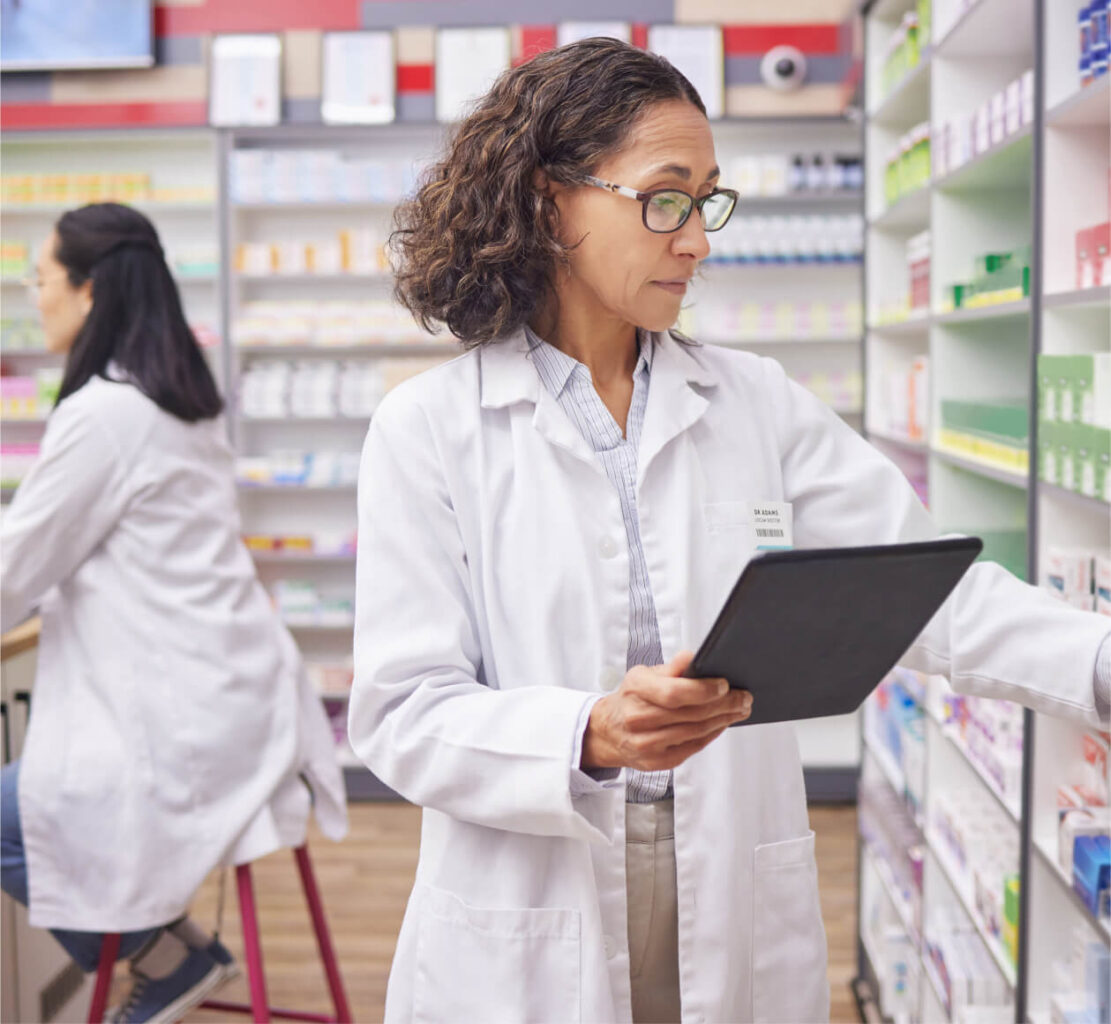 A pharmacist looking on the shelves for a cancer patient's prescription medicine