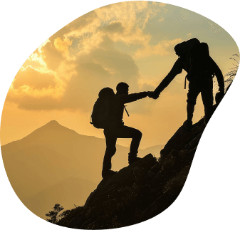 Two mountain climbers going up a mountain, one helping the other